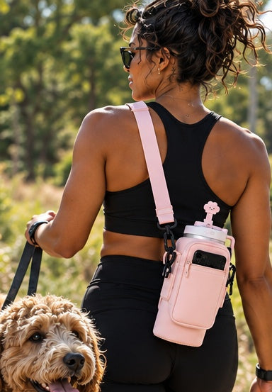 SIP & STASH pink bottle carrier on a dog walk
